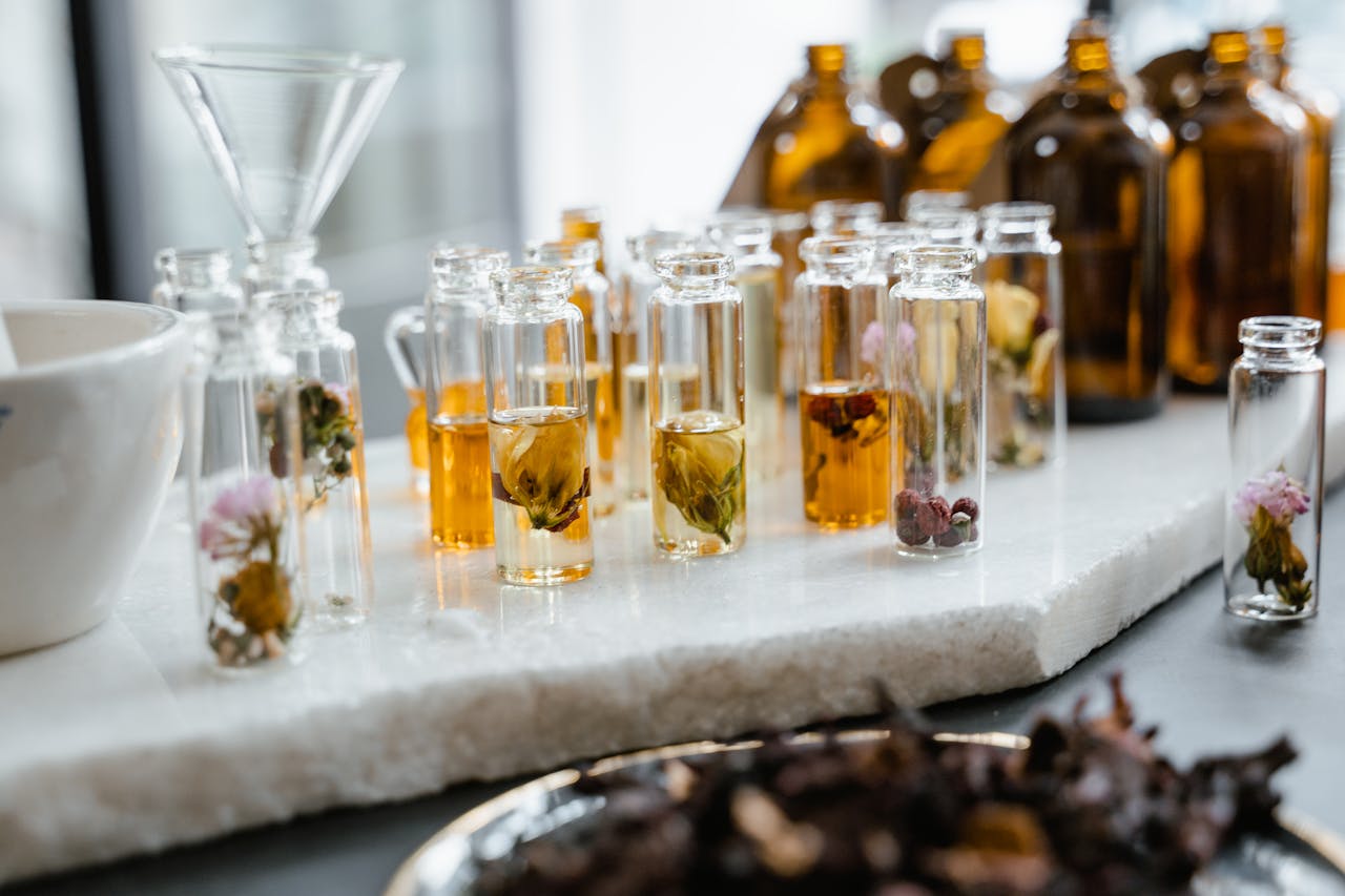 why-choose-us Close-up of various aromatic floral oils in glass bottles, showcasing their vibrant colors and natural ingredients.